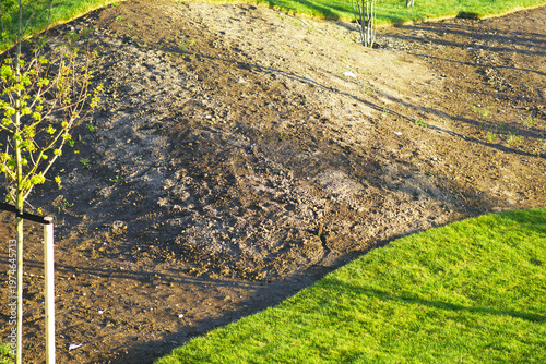 Vászonkép Curved boundary between freshly laid grass and raw soil highlighting terrain shaping in newly developed park