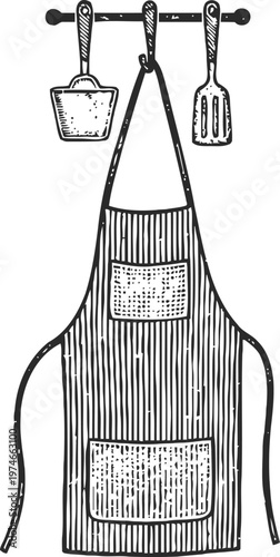 Kitchen apron with pockets hanging on a rack with spatula and scoop utensils