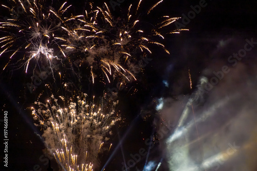 Fireworks bursting across dark night sky in vivid photo style on black background, concept of celebration and festive energy