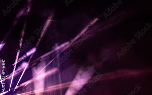 Purple light streaks in motion blur, abstract style on dark background, concept of energy and nightlife