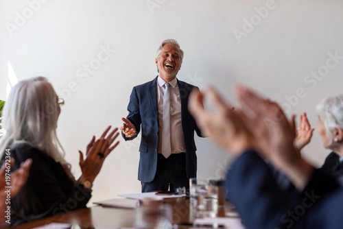Fotografie Joyful speaker engaging enthusiastic audience