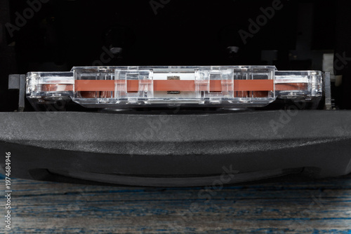 Collection of cassette tape in a recorder.  Audio cassette tape in player. Vintage media concept. Top view. Retro acoustic.