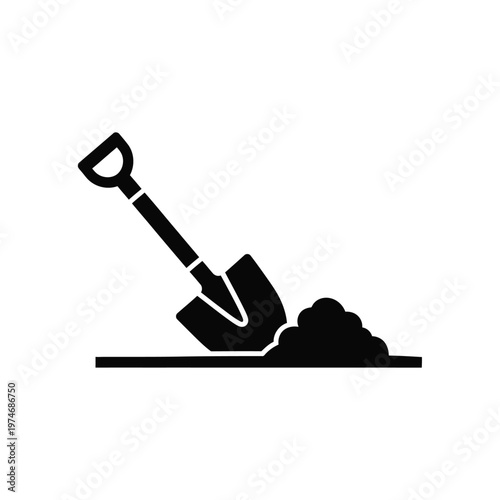 Black shovel digging dirt on ground
