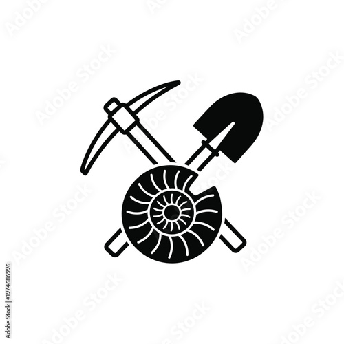 Black pickaxe shovel and ammonite fossil