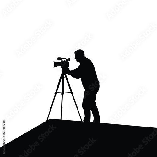 Silhouette of cameraman filming with camera on tripod outdoors