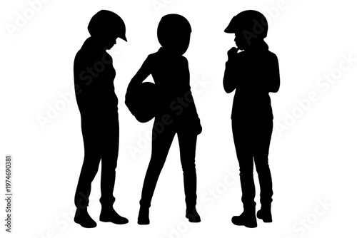 Silhouettes of three young equestrians wearing helmets and standing together