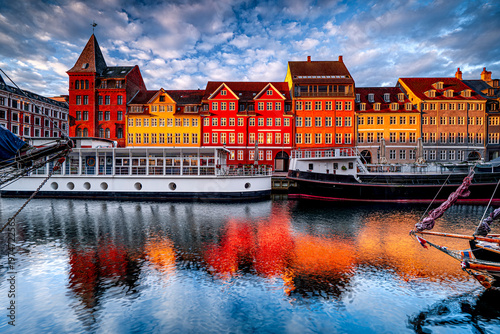 Colorful architecture in Copenhagen at sunrise, Nyhavn canal with boats, Denmark