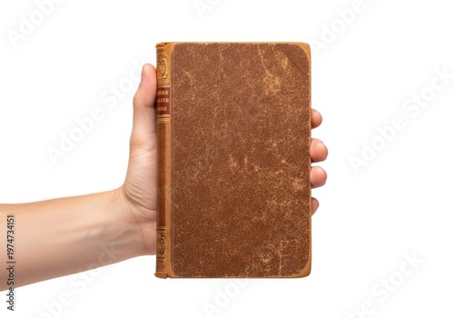 A hand holding an old worn brown hardbound book isolated against a plain white background area