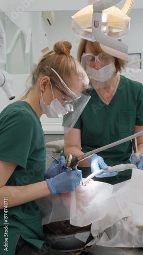 Dentist performs air abrasion procedure using specialized sandblasting nozzle. High pressure mixture of water and bicarbonate powder effectively removes dental plaque and stubborn stains