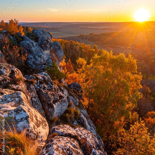 A scenic vista showcasing the golden hour. Rugged, sunlit rocks frame an expansive valley & vibrant autumnal forest, bathed in warm sunset hues
