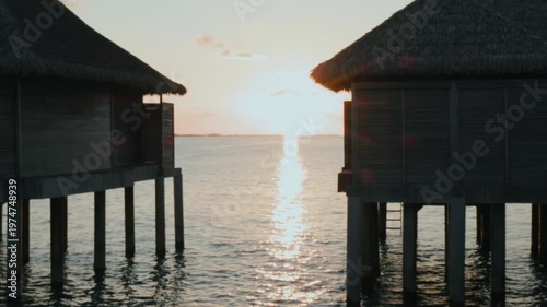 sunset on the Maldives' beach between the villas