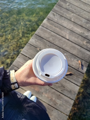 Fotografie A leisurely walk with a cup of coffee in your hands