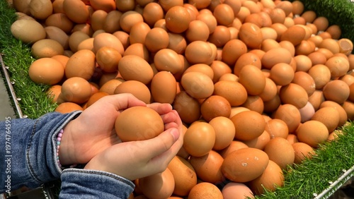 Kids hand picking some egg at groceries store