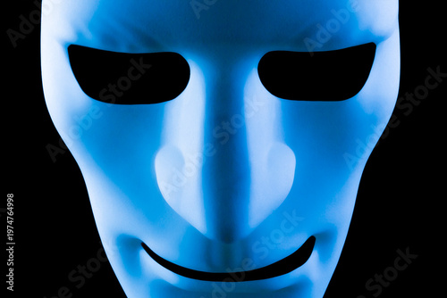 Artificial intelligence robot mask or face staring at the camera. Blue robotic android taking over the workplace concept