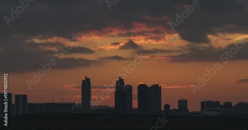 Sunset footage between the city and buildings. Dance of clouds above the buildings. Cloud movements captured with time lapse technique.