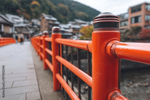 Vibrant Red Bridge Railing Detail With Blurred Autumn Village Scene In The Background Serene And Picturesque Landscape