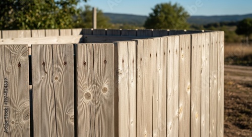 Close-up view of sun-bleached, weathered pine planks forming an outdoor wooden fence with visible grain and texture