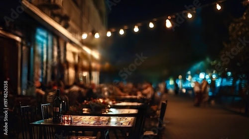 Outdoor cafe tables glowing at night with string lights