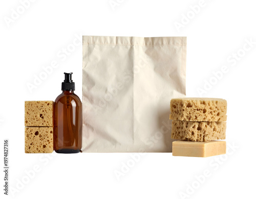 Amber bottle, sponges, soap, and canvas bag on white