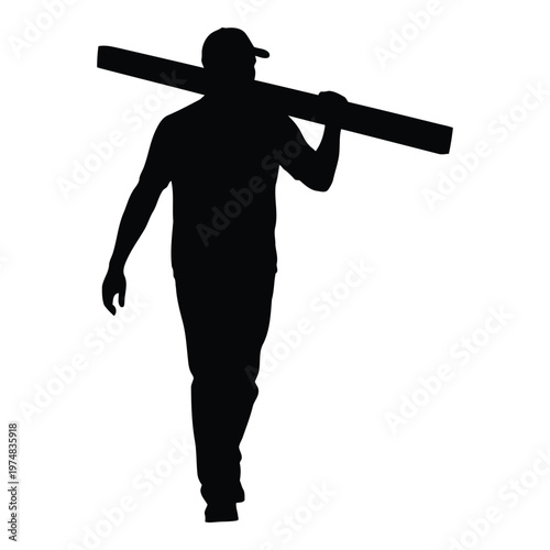 A lone male silhouette wearing a baseball cap and casual clothing walks confidently carrying a long plank of wood balanced across his right shoulder
