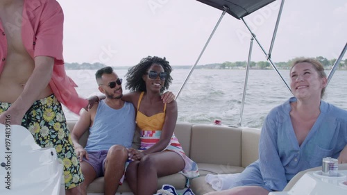 Wallpaper Mural Friends relax and have fun on a moving speedboat as a couple hugs and has a good time. Torontodigital.ca