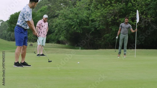 Wallpaper Mural A man putts his ball into the hole and misses as two of his friends watch. Torontodigital.ca