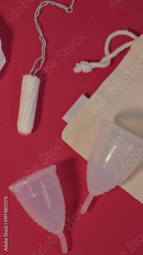 Flatlay Menstrual Cups And Tampon On Red Backdrop Showing Product Comparison, Cloth Pad Accent, Contrast Between Reusable Silicone Cup And Disposable Cotton Tampon, Educational Consumer Choice Framing