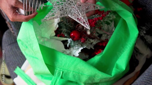 Person preparing christmas holiday tree decorations