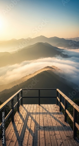 Elevated wooden observation deck offering a breathtaking panoramic perspective of dense mountain peaks shrouded in morning mist and golden atmospheric light, tourism, range, wideangle