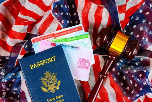 Bild auf Leinwand Documents related to United States citizenship immigration lay on an American flag with court gavel nearby