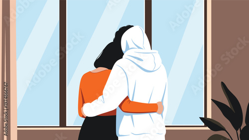 Rear view of a young couple hugging each other while looking out of a window in a peaceful and cozy indoor setting.