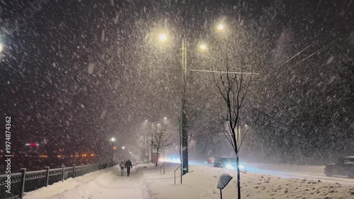 A snowstorm and snowfall on the evening streets of the city. The city is buried in snow. Ternopil, Ukraine, 