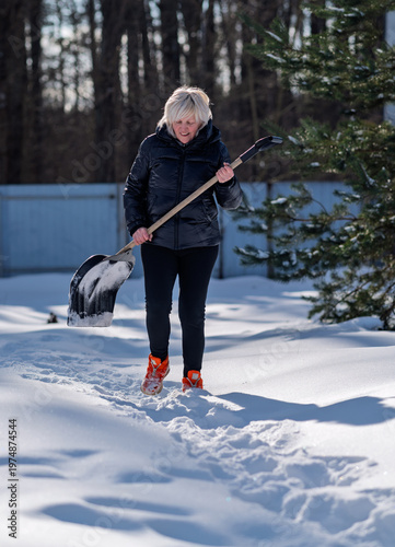 A woman returns from clearing snow.