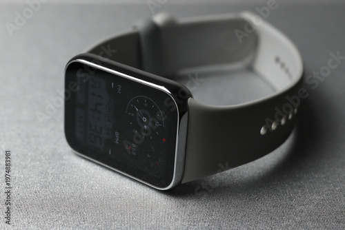 Smart watch with gray silicone strap on dark background