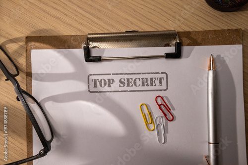 Top View of a Top Secret Document on a Clipboard with Colorful Paperclips