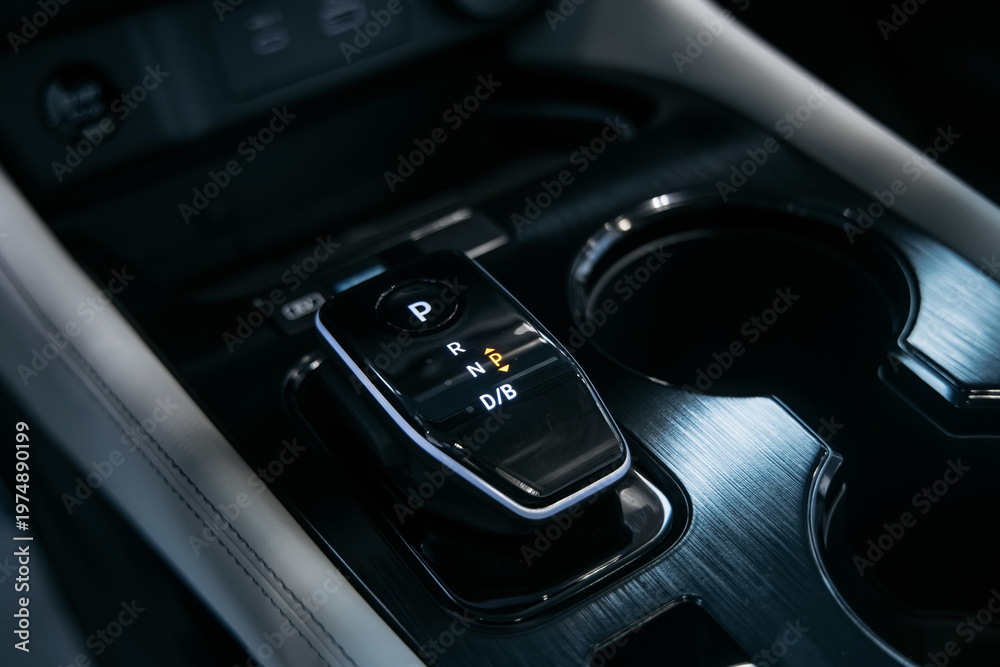 Obraz premium Close up of car center console with gear shift and touchscreen controls. Automotive technology concept.