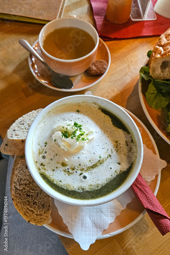 Nettle soup with cream and bread served in restaurant