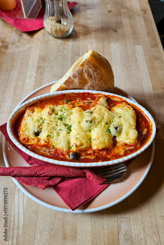 Baked lasagna with melted cheese and tomato sauce