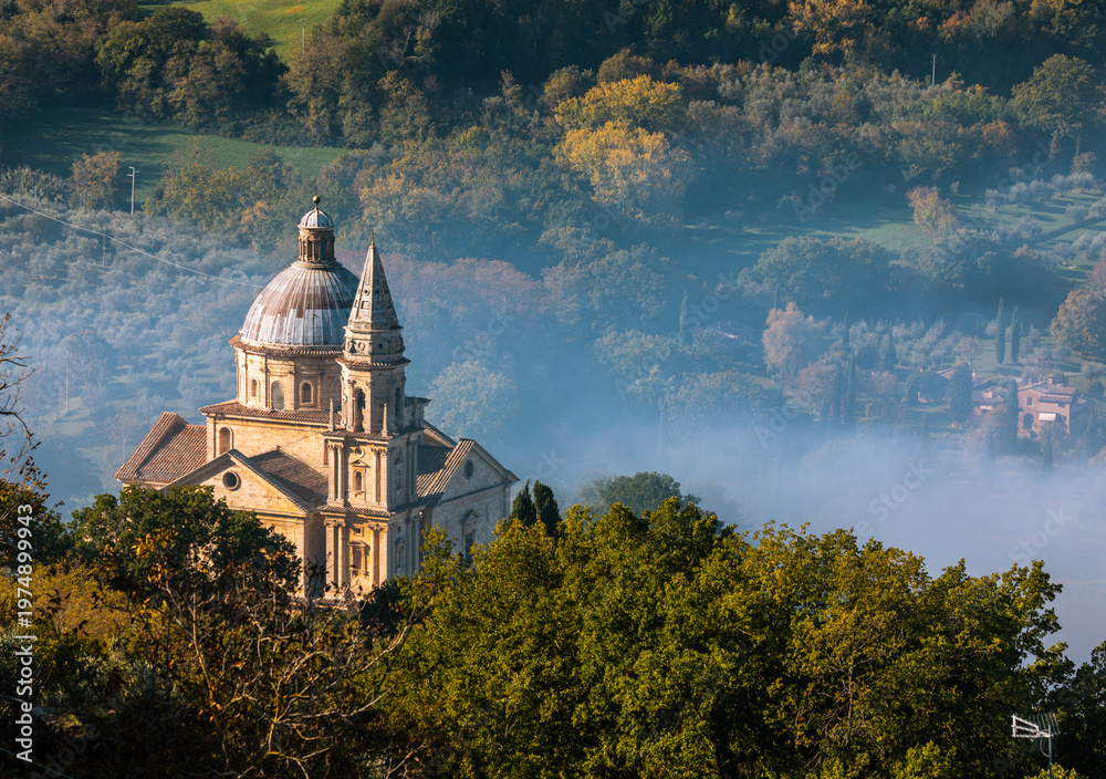 Naklejka premium Tempio di San Biagio in Montepulciano valley shrouded in morning mist, Italy.