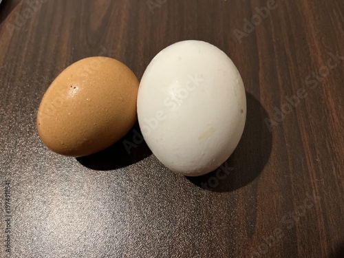 Natural farm fresh eggs brown and white on dark background for organic produce concept