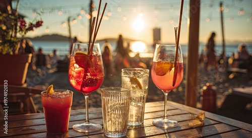 Drinks at sunset on a beach with string lights above