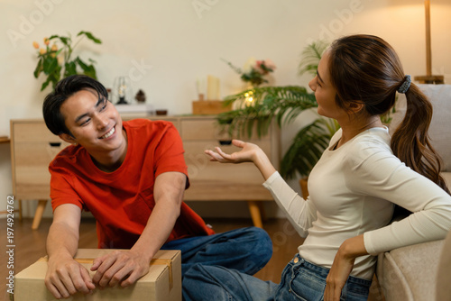 Couple Taking a Break and Talking Among Moving Boxes at Home