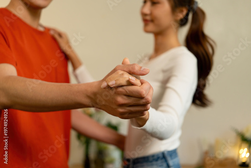 Close-Up of Loving Couple Holding Hands and Dancing at Home