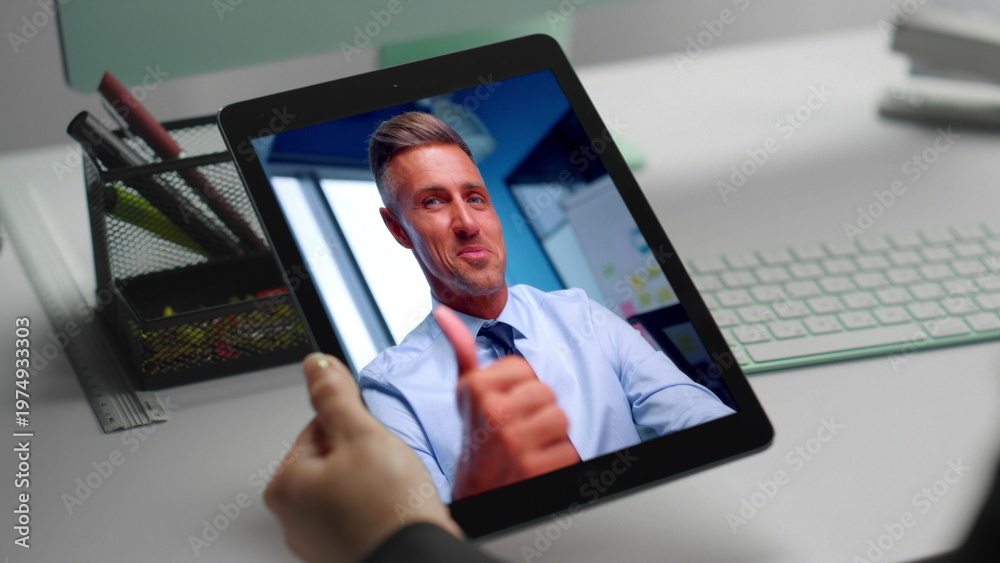 Fototapeta premium Smiling manager chatting web camera tablet call with coworker at office closeup