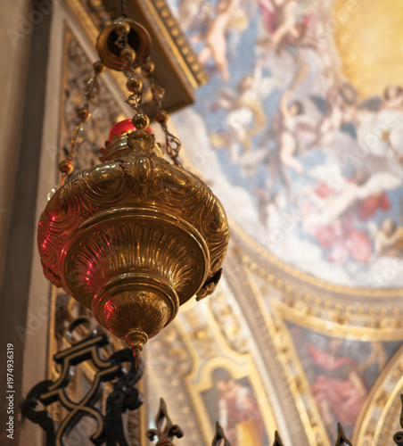 Votive lamp hanging in church, creating a spiritual atmosphere. Ornate votive lamp illuminates a church, symbolizing faith, hope, and devotion in a sacred space