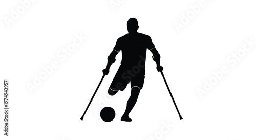 A man with crutches playing soccer depicted in a dark silhouette