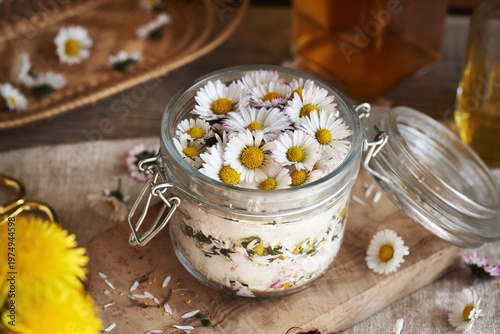 Preparation of herbal syrup from common daisy flowers in a glass jar
