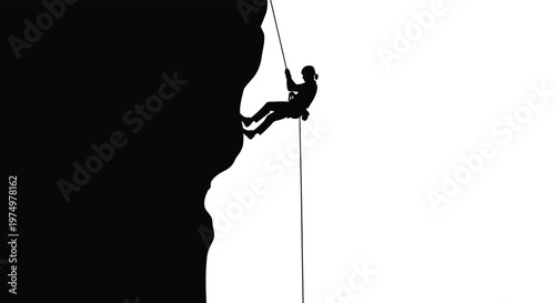 A silhouetted rock climber descends a steep cliff face using a rope and harness high quality