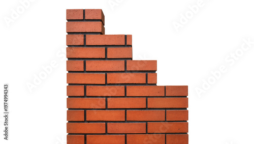 Fotografie Isolated unfinished red brick wall section with stepped edge, a building and con