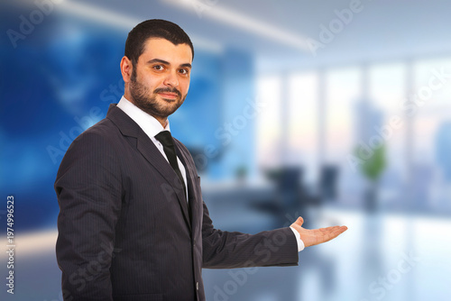 Dressed in a formal suit, the man smiles confidently